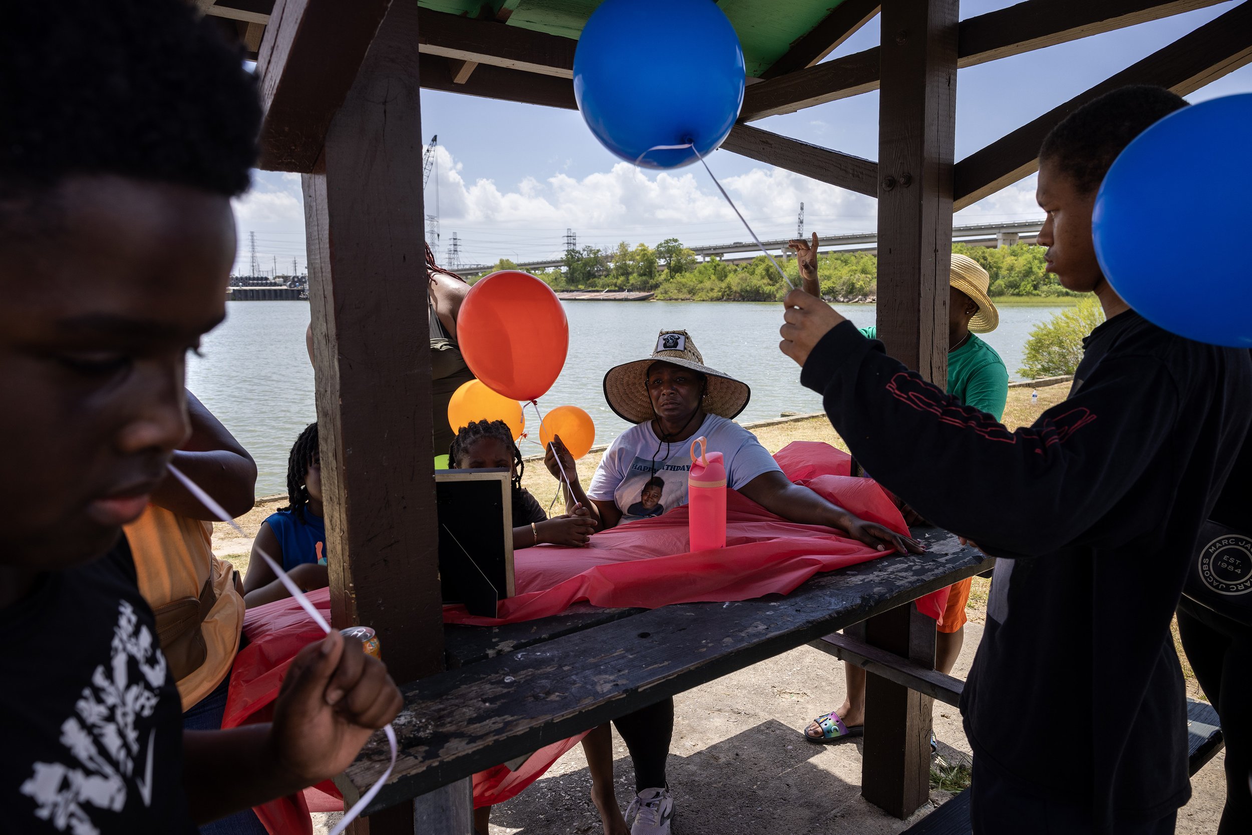  LaTonya Payne, at center, along with family members prepare to release balloons to honor what would have been Corinthian Giles’s, Payne’s son, 16th birthday celebration at Roseland Park, Saturday, Aug. 12, 2023, in Baytown. Corinthian passed away at