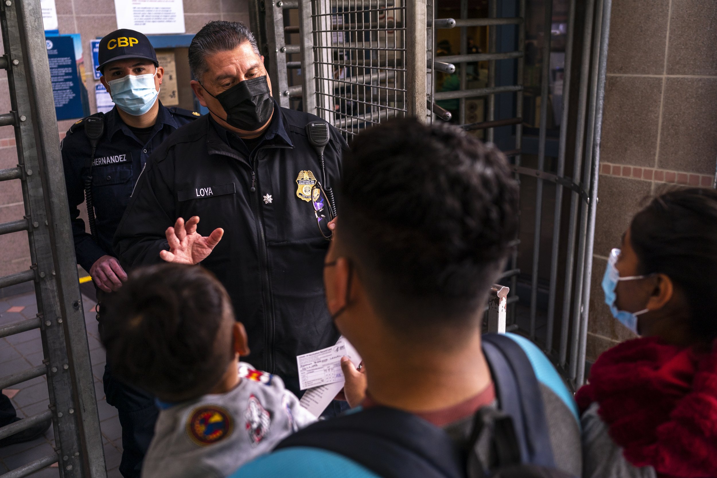  Nancy and Leo, along with their two children Alexander, 3, and Gael, 1, present their COVID-19 vaccination cards while speaking with a Border Patrol officer to seek asylum at the U.S. Customs and Border Protection - Dennis DeConcini Port of Entry on