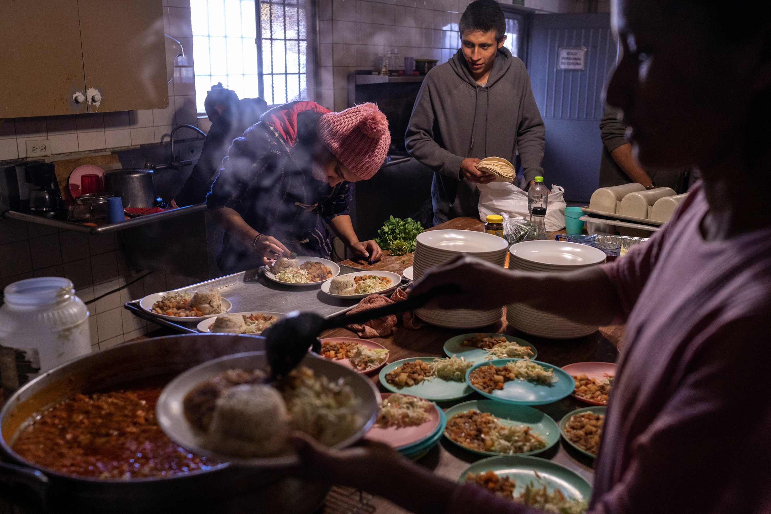  A group of migrants, who’s names have been omitted for safety concerns, help cook a meal for over 50 migrants at La Casa de Misericordia on Friday, Jan. 7, 2023, in Nogales, Mexico. The migrant shelter requires residents to contribute to daily tasks