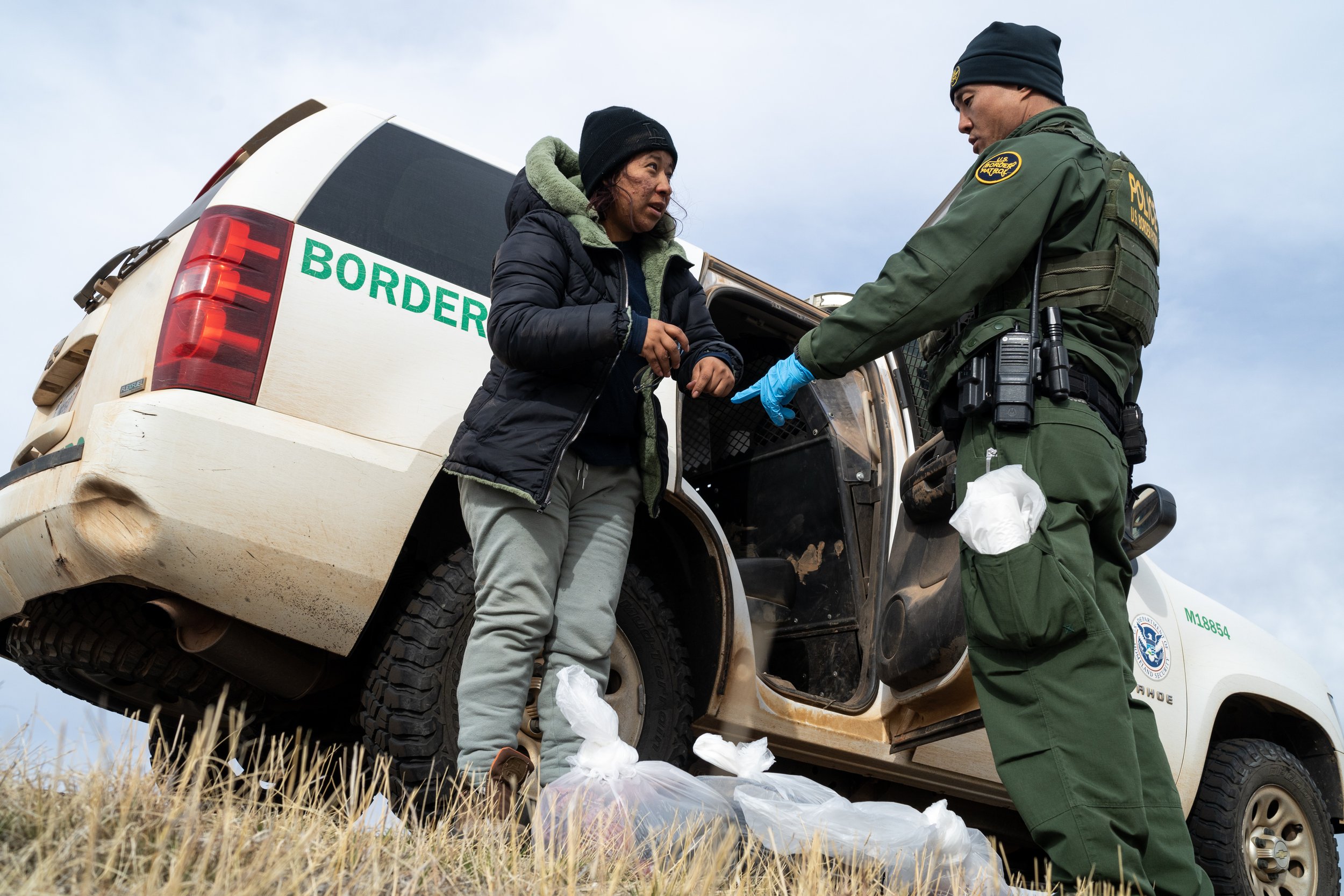  A migrant woman is detained by U.S. Border Patrol on suspicion of illegally entering the United States of America on Friday, Feb. 17, 2023, in Hereford. The woman, along with two other migrants, allegedly got into a car that was waiting for them on 