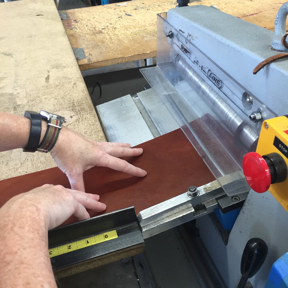  1. The leather is cut to width. Yes, those are my hands feeding it into the cutting machine! 