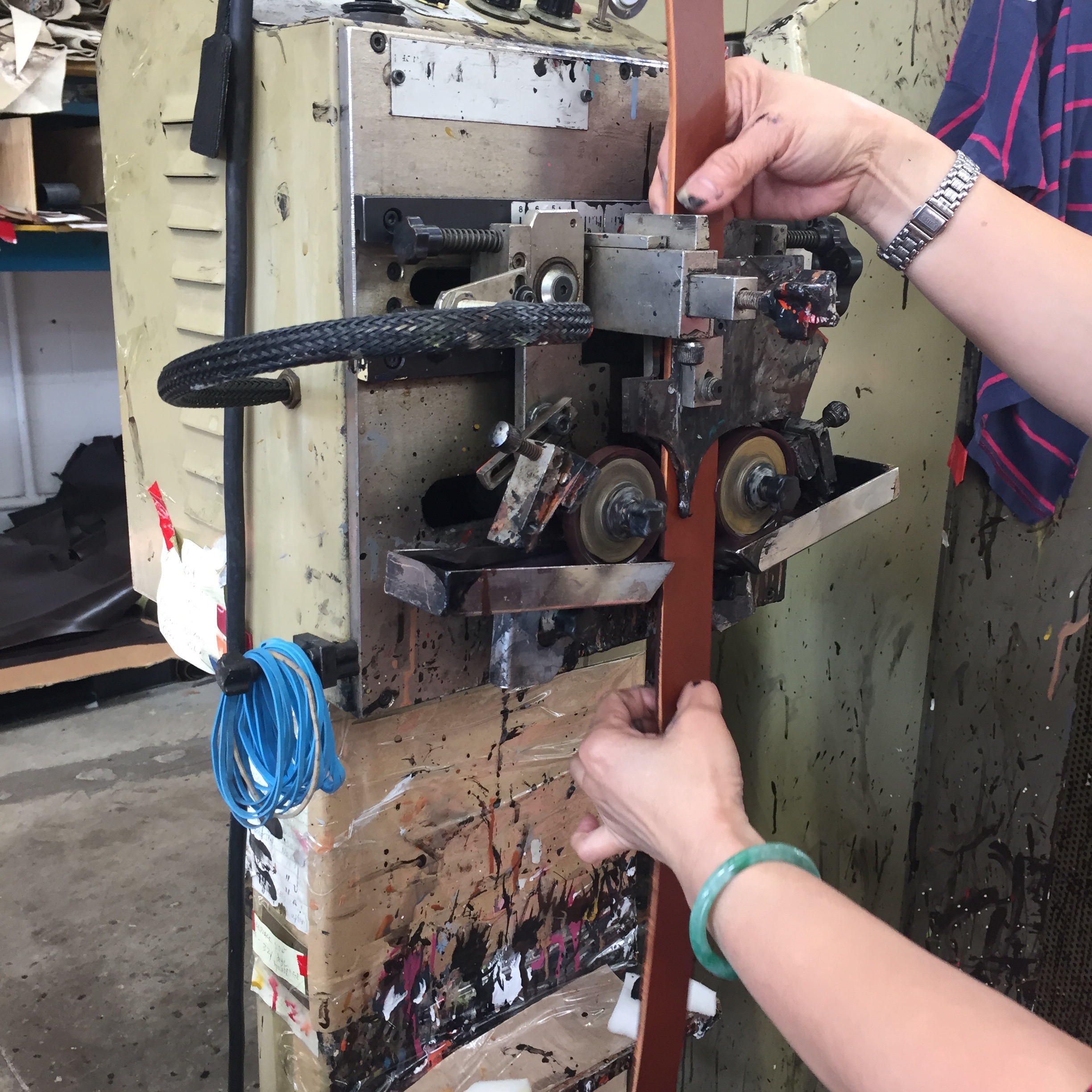3. Dye is applied to cut edges. That's Ahn Bui with my belt — she is the longest-serving Brave employee and has been with the company since 1994.