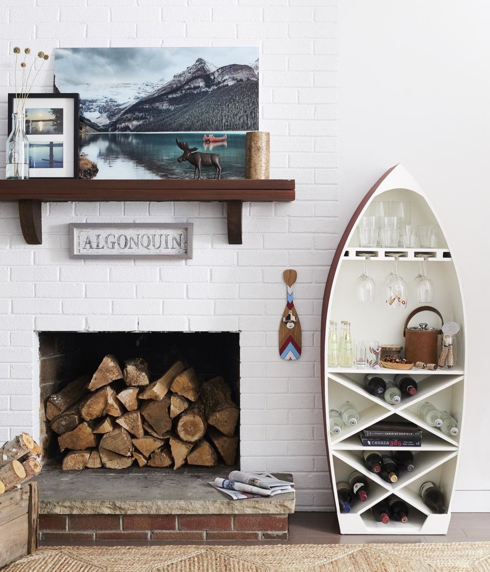  I thought the dory boat bar cabinet was a cutie — could not resist featuring that one. That photograph art of Lake Louise is an absolute stunner and printed on glass. We giggled on set about how the moose sculpture is placed so it looks like he's wa