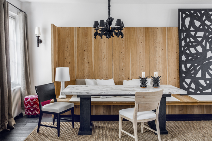 The dining area features table and chairs by the designers. The sconce and chandelier are by Christian Astuguevieille. 