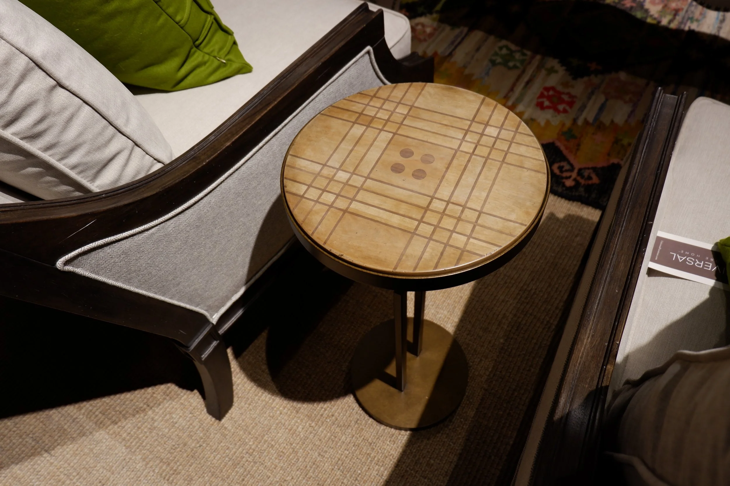 Button design on the top of a side table by Alexander Julian.