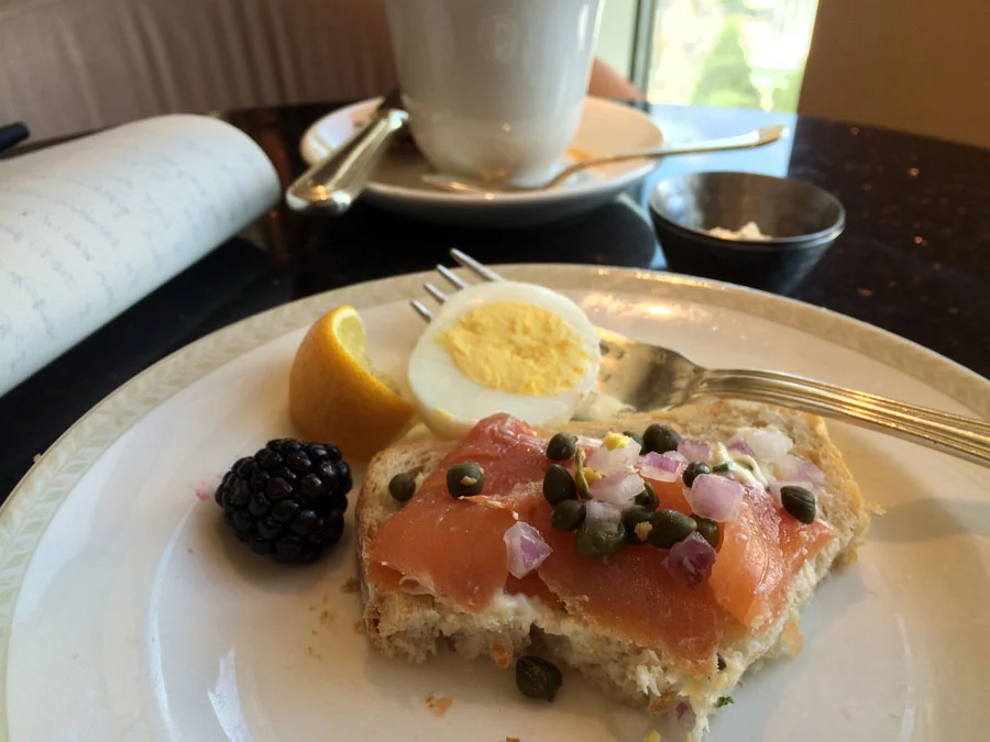 Loungin Breakfast : coffee, salmon with red onions and capers on toast, eggs, blackberries.