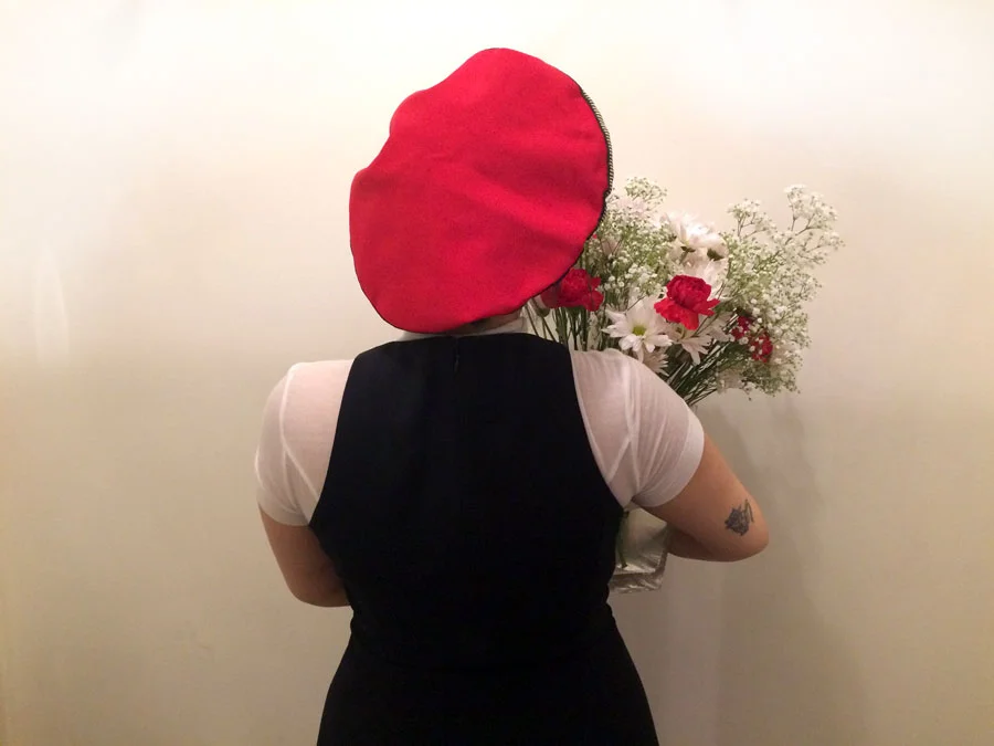 Join the Dechoes Red Berets Union. Ivanna proudly holds her arrangement for the daily IG shot (@dechoesresale) . She is wearing her own clothes and a red vintage beret with striped gold lamé trim from Jean Charles Brosseau for Bergdorf Goodman .