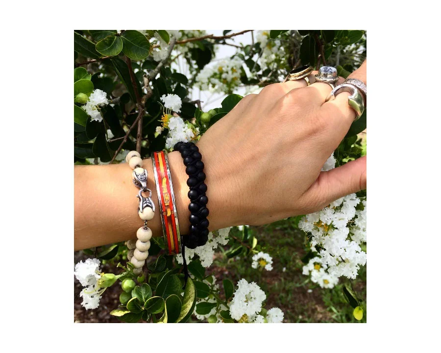 Beaded David Yurman bracelets. Printed enamel belt print metal bangle from Hermes . 