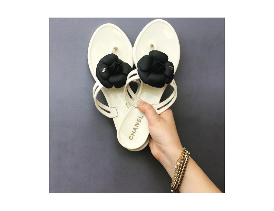Creme and black jelly sandals with iconic camellia flowers. 