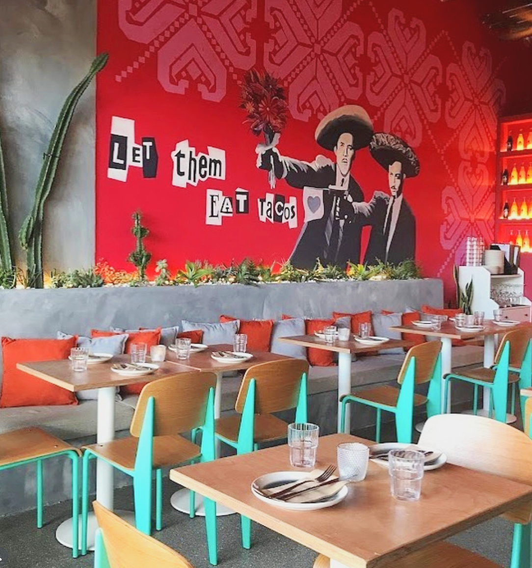 Relaxed holiday atmosphere at Kirra Point with surfers and families