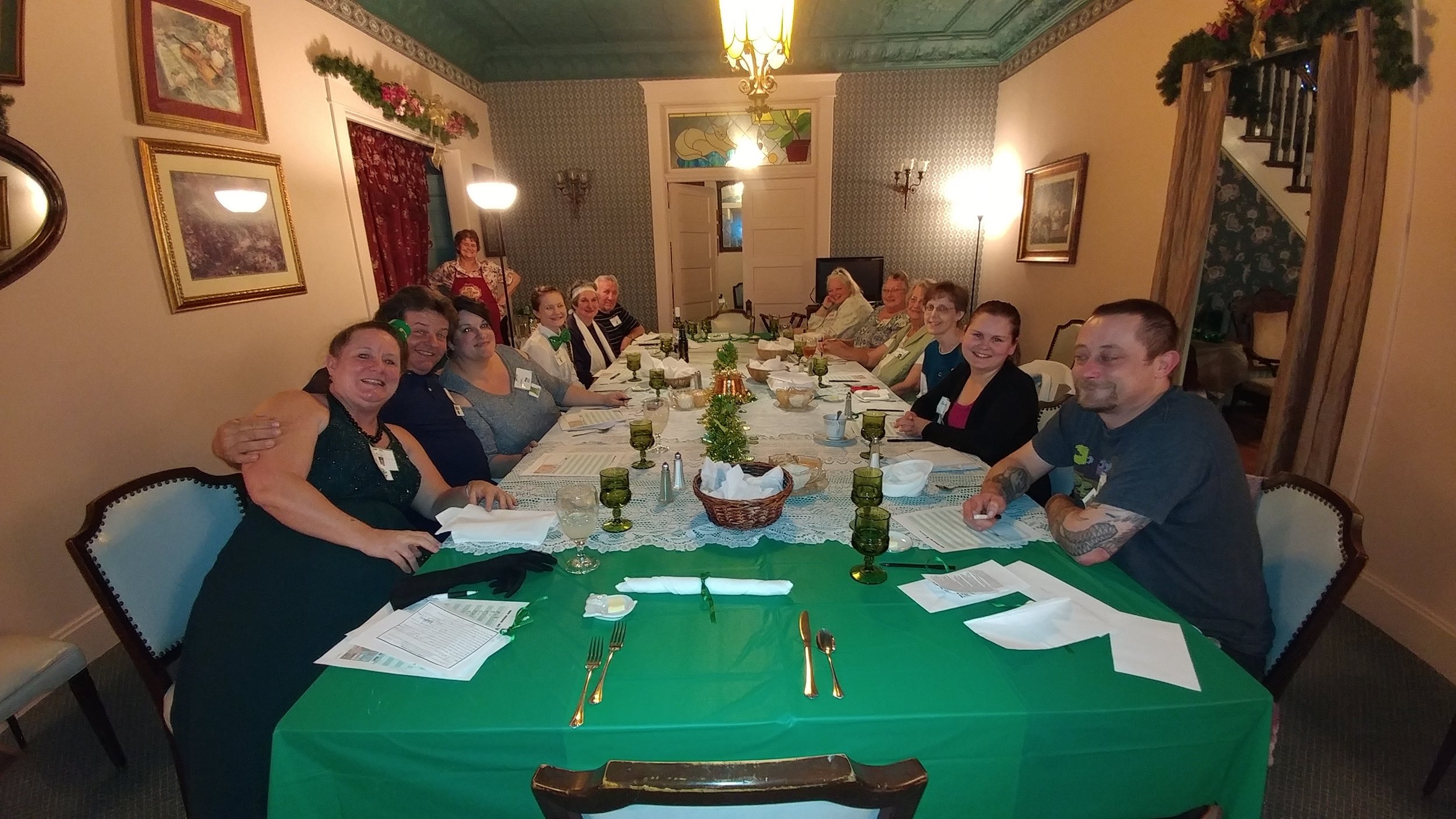  Murder mystery guests all smiles. The poor murdered one is the lady on the right way in the back at the very end of the table. 