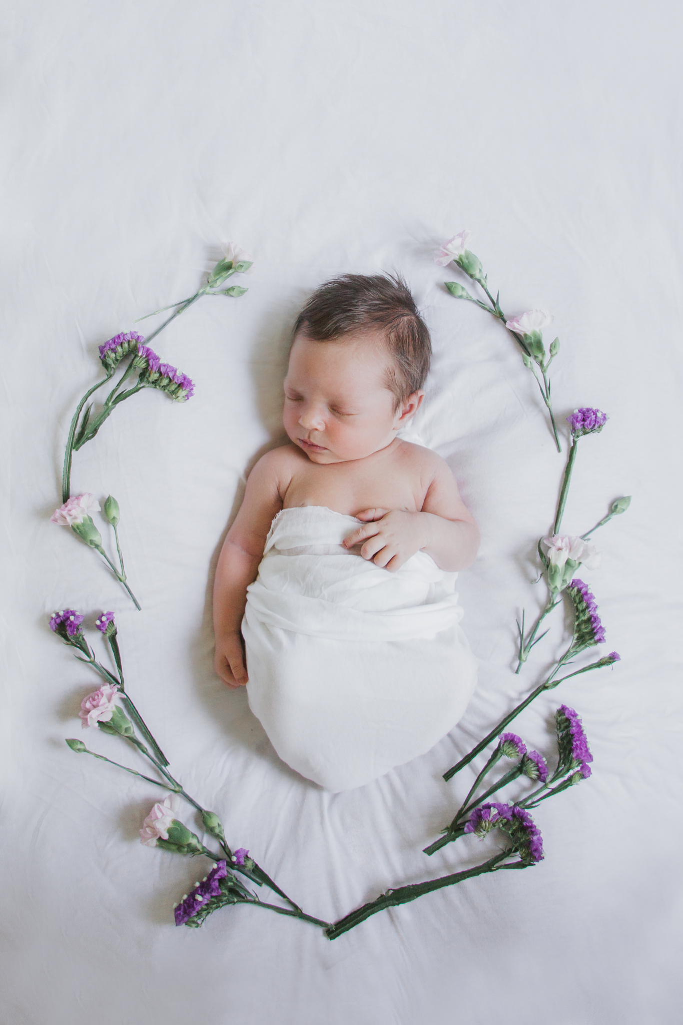 newborn with flowers