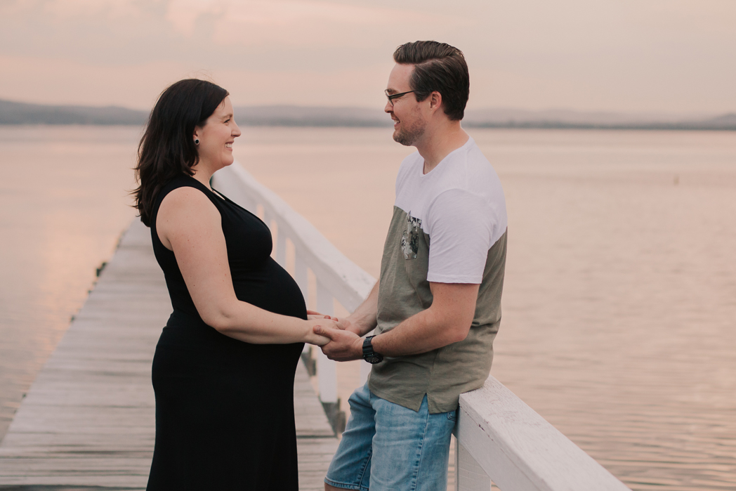 couple holding hands at maternity session