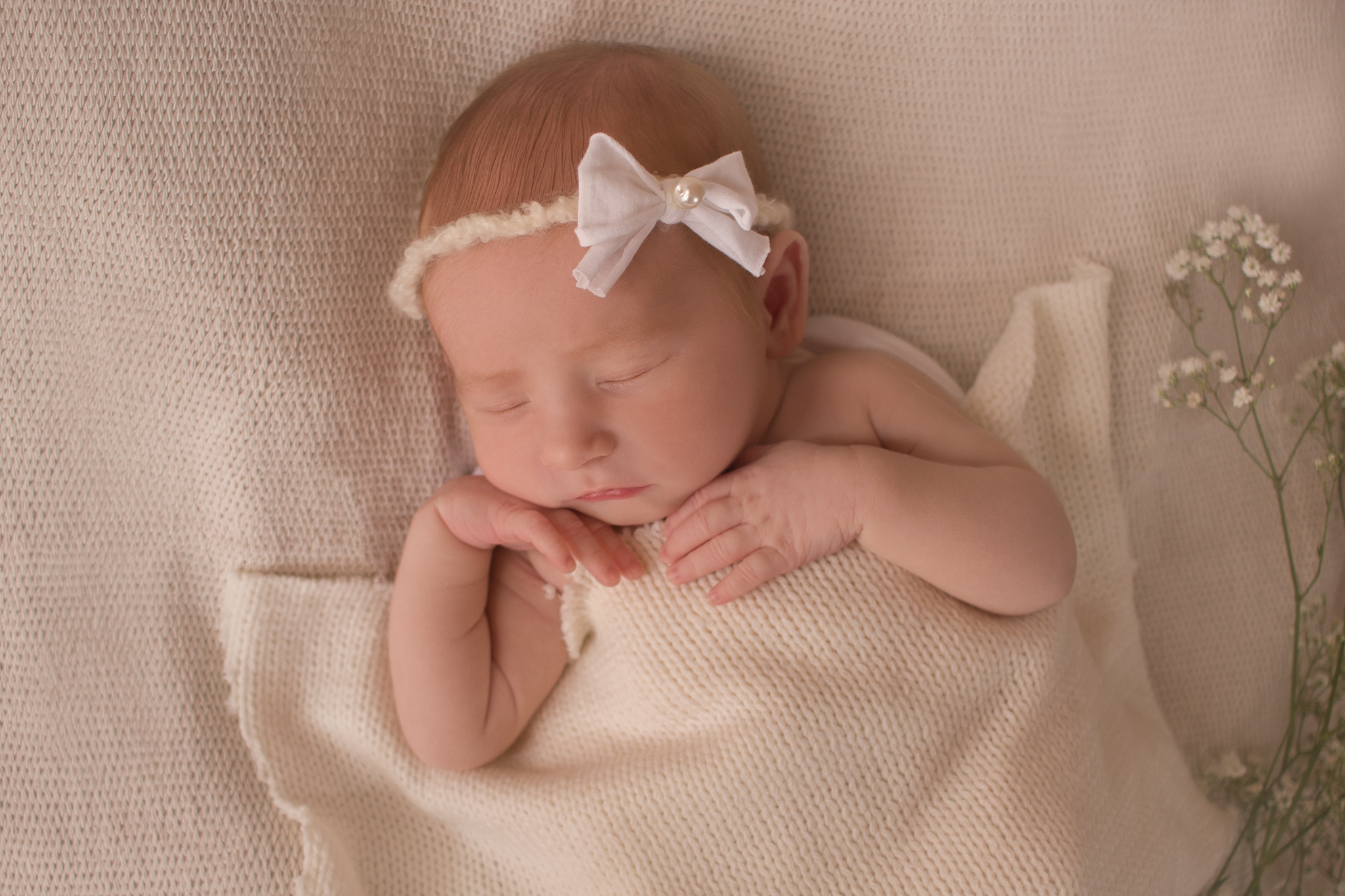 newborn girl sleeping tucked in