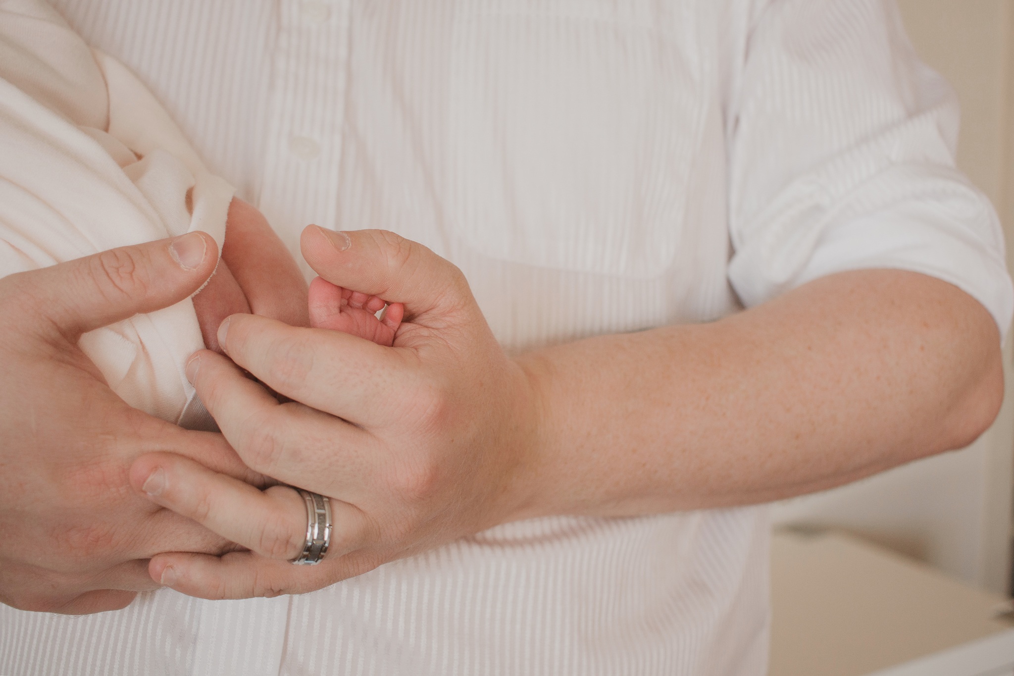 tiny baby toes in dads hand