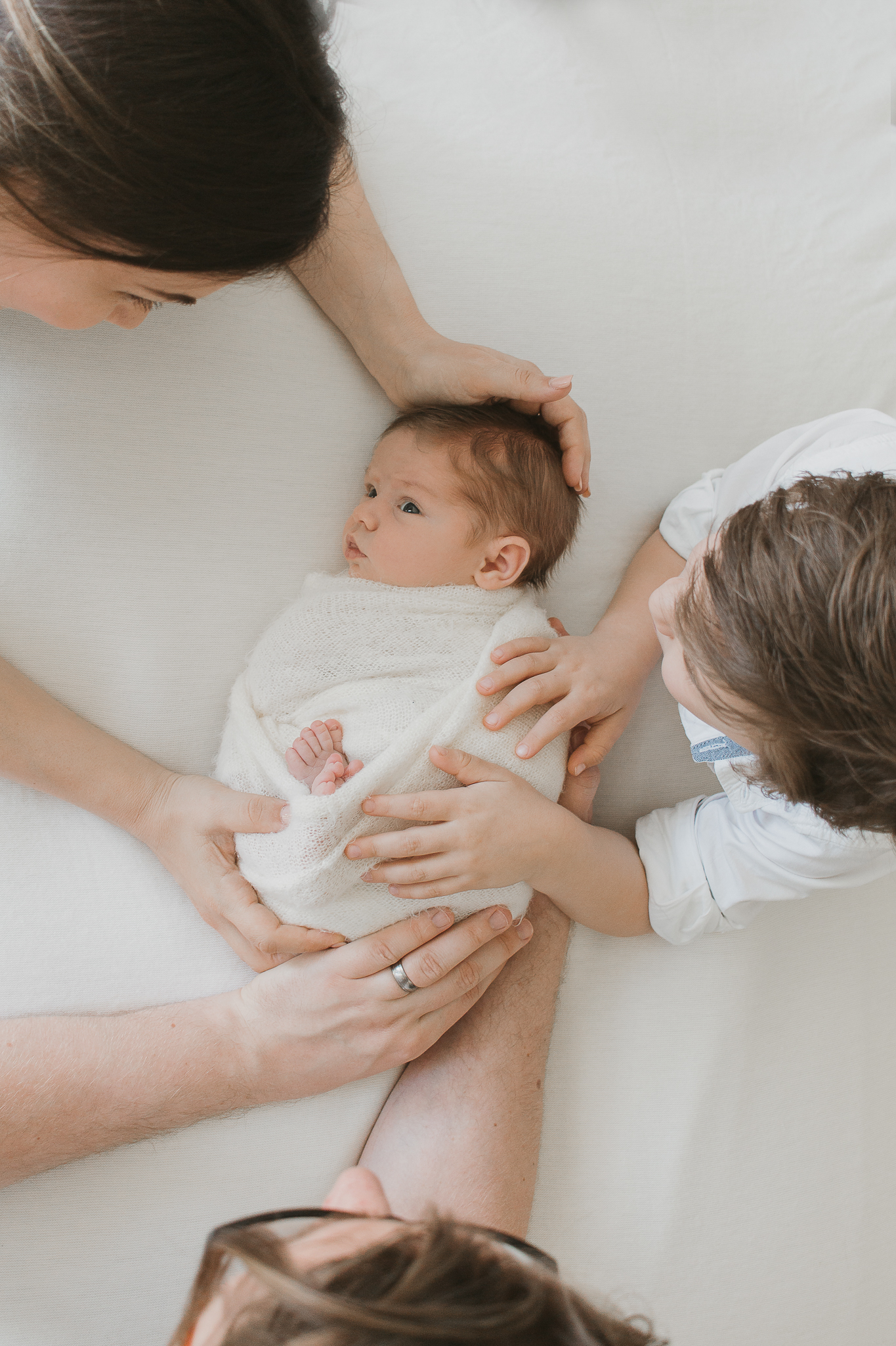 all family hands on baby