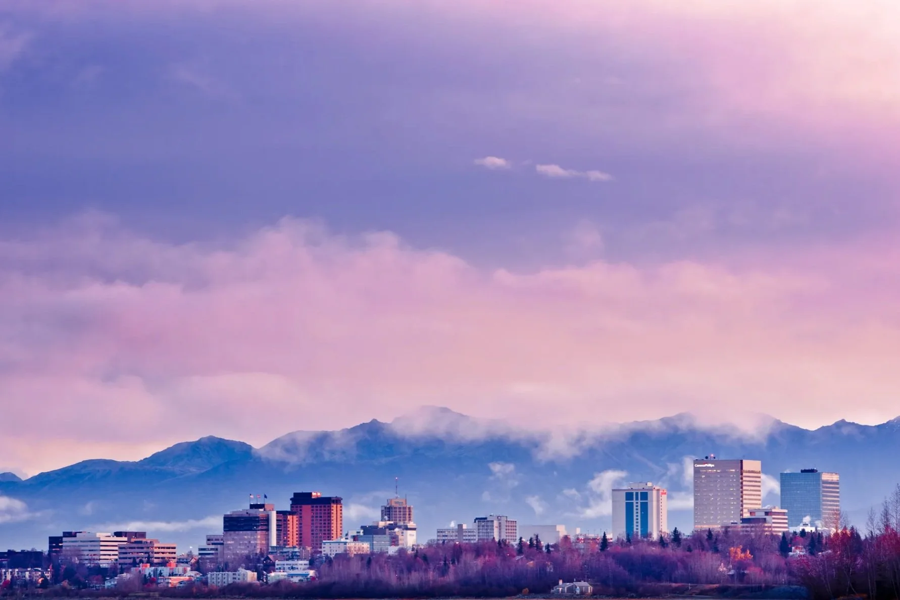 pink image of anchorage city at sunset.