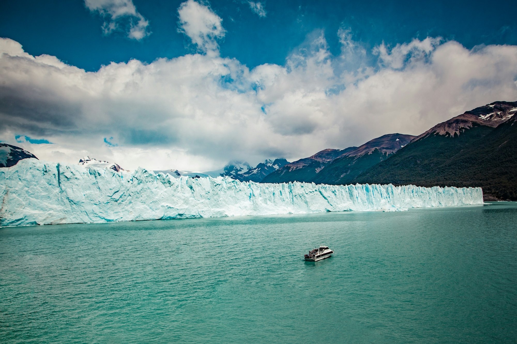 small boat in front of tidewater glacier.