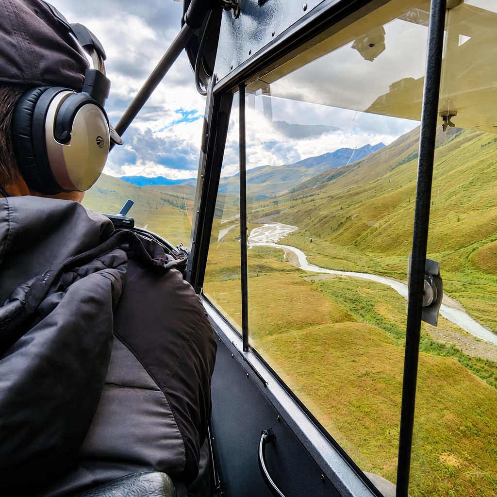 man flying in bush plane over talkeetnas