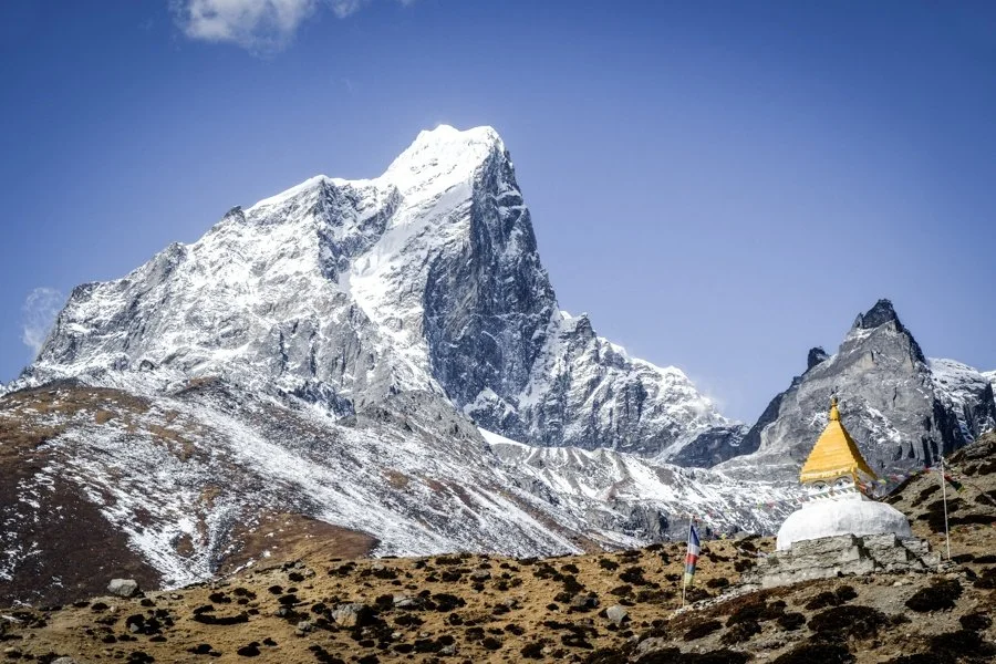 Snow capped peak with temple in foreground