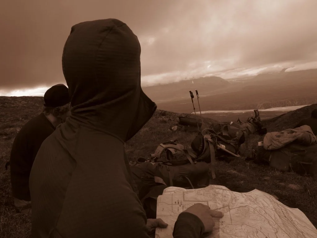 Person reading a  topo map in the wilderness.