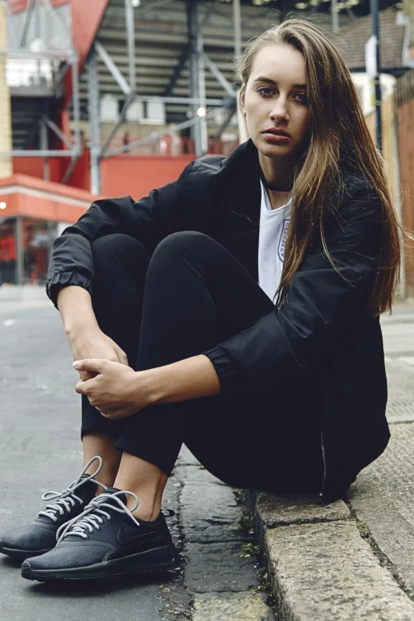 Sarah: H&M jacket, Nike England jersey, Levi’s jeans, Nike Beautiful x Air Max Thea Ultra Premium trainers, ropeslaces.com laces