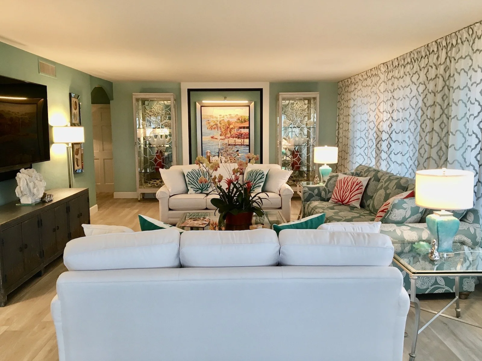 Luxury coastal, tropical living room with 2 white sofas and one sofa aqua and white at Ocean Reef Club