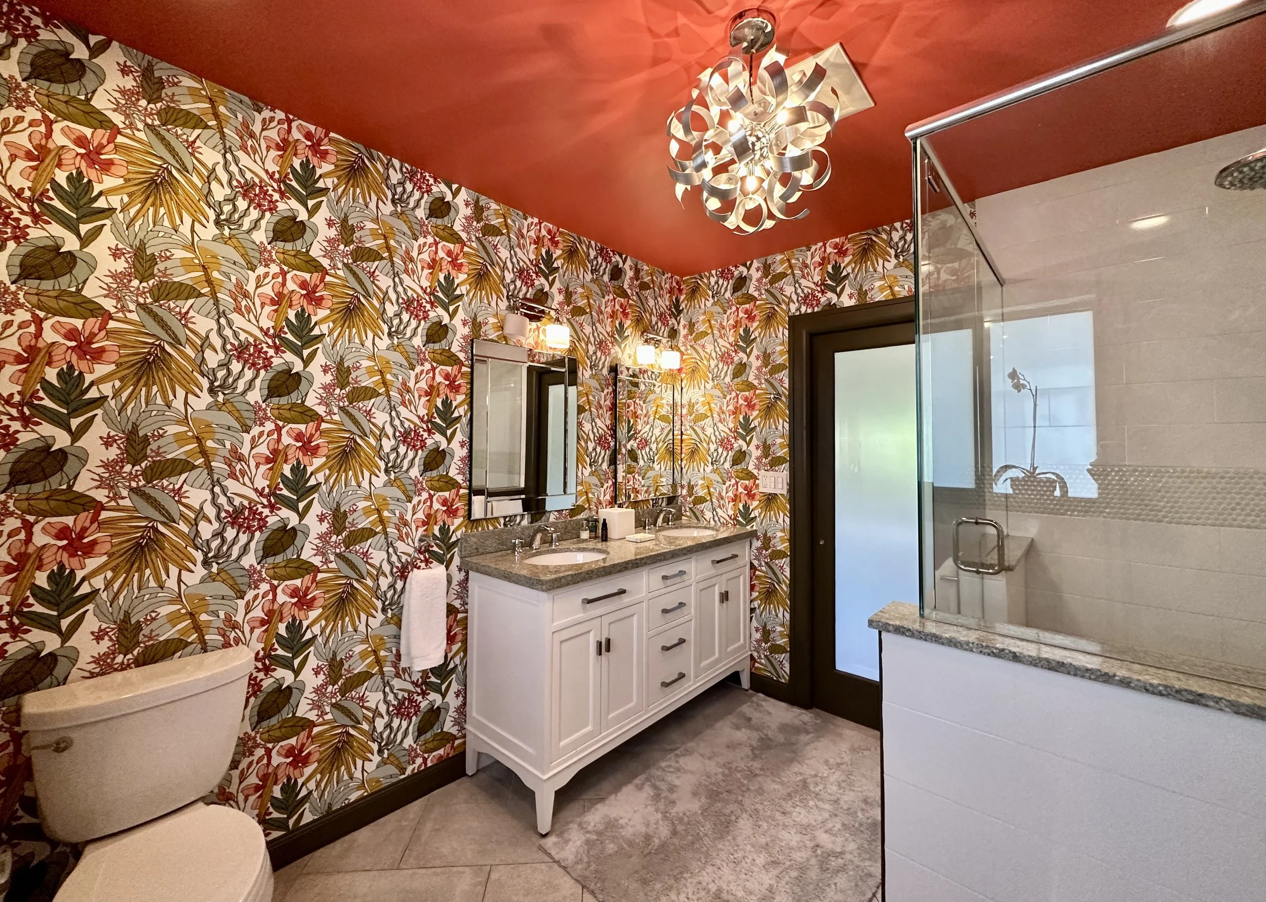 Modern bathroom with tropical flower wallpaper and coral red ceiling in Fort Lauderdale