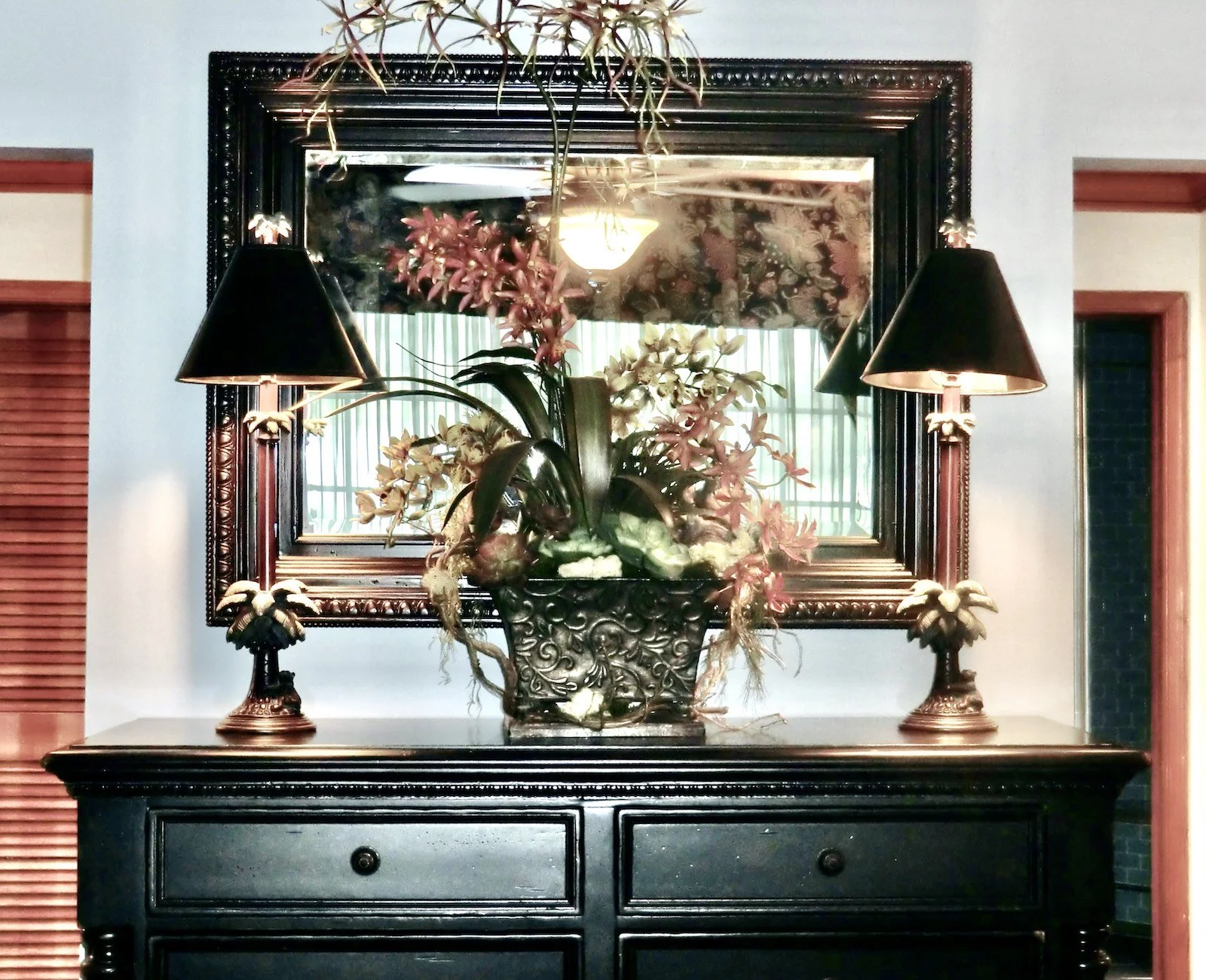 Luxury Tropical bedroom with Tommy Bahamas black dresser with two tropical lamps and flowers