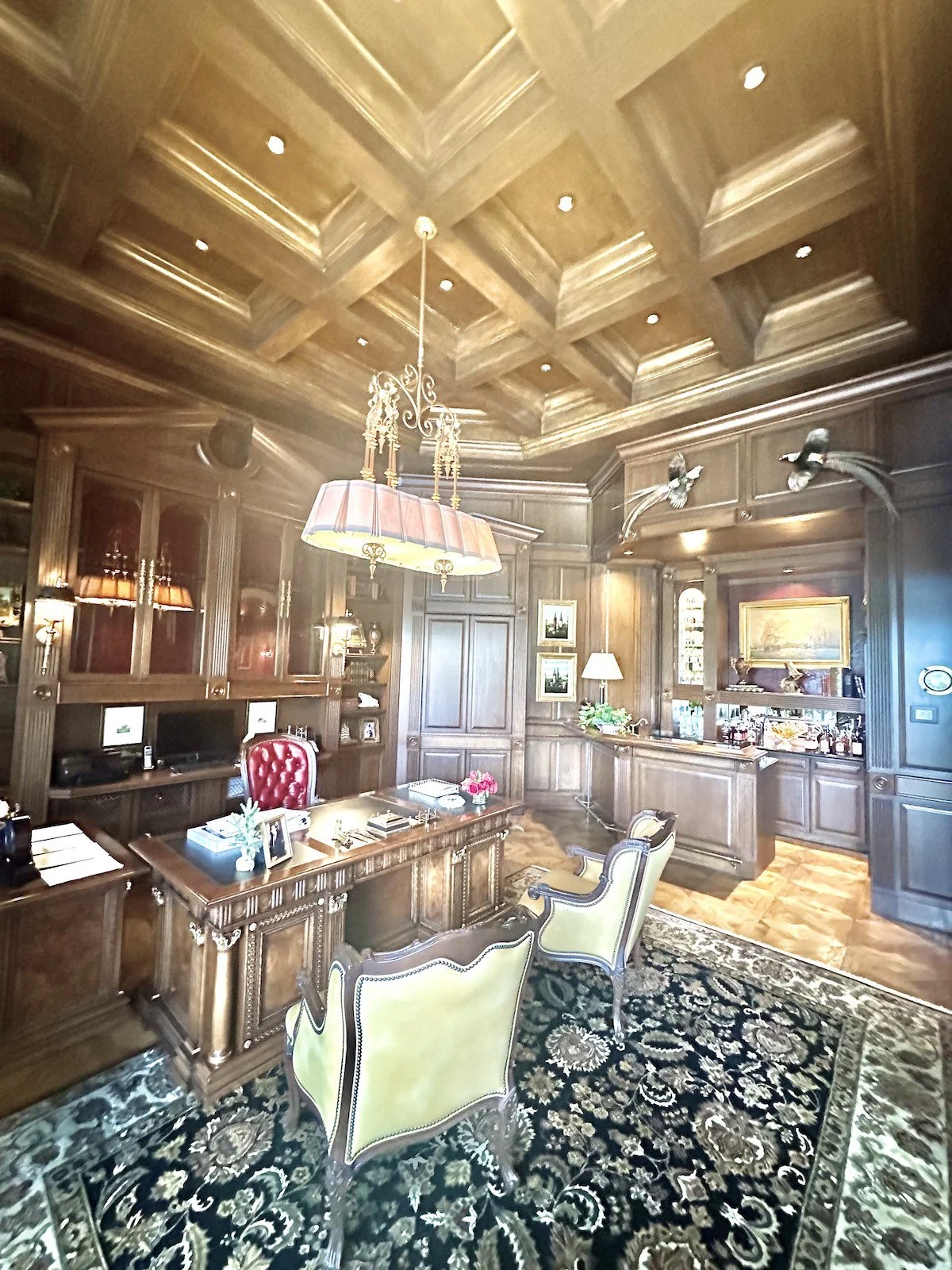 Custom home office and library with a bar and coffered ceiling
