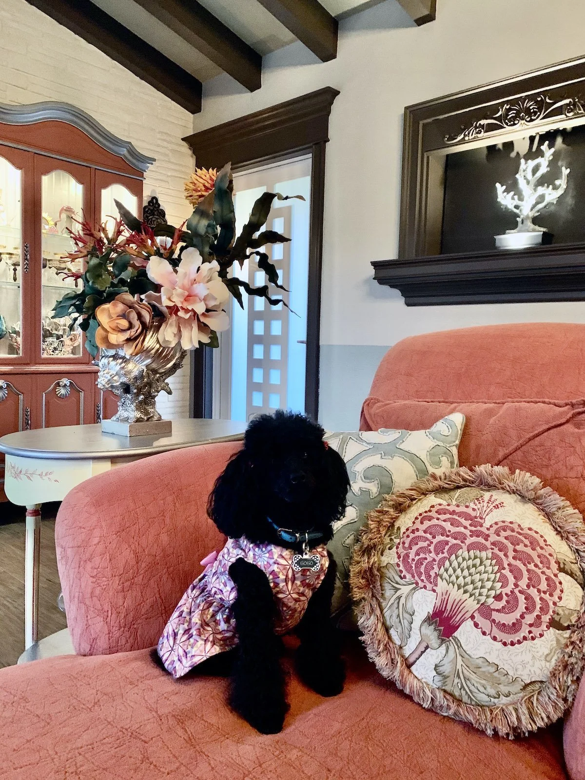 Transitional coastal style living room with coral color sofa and hutch in Fort Lauderdale