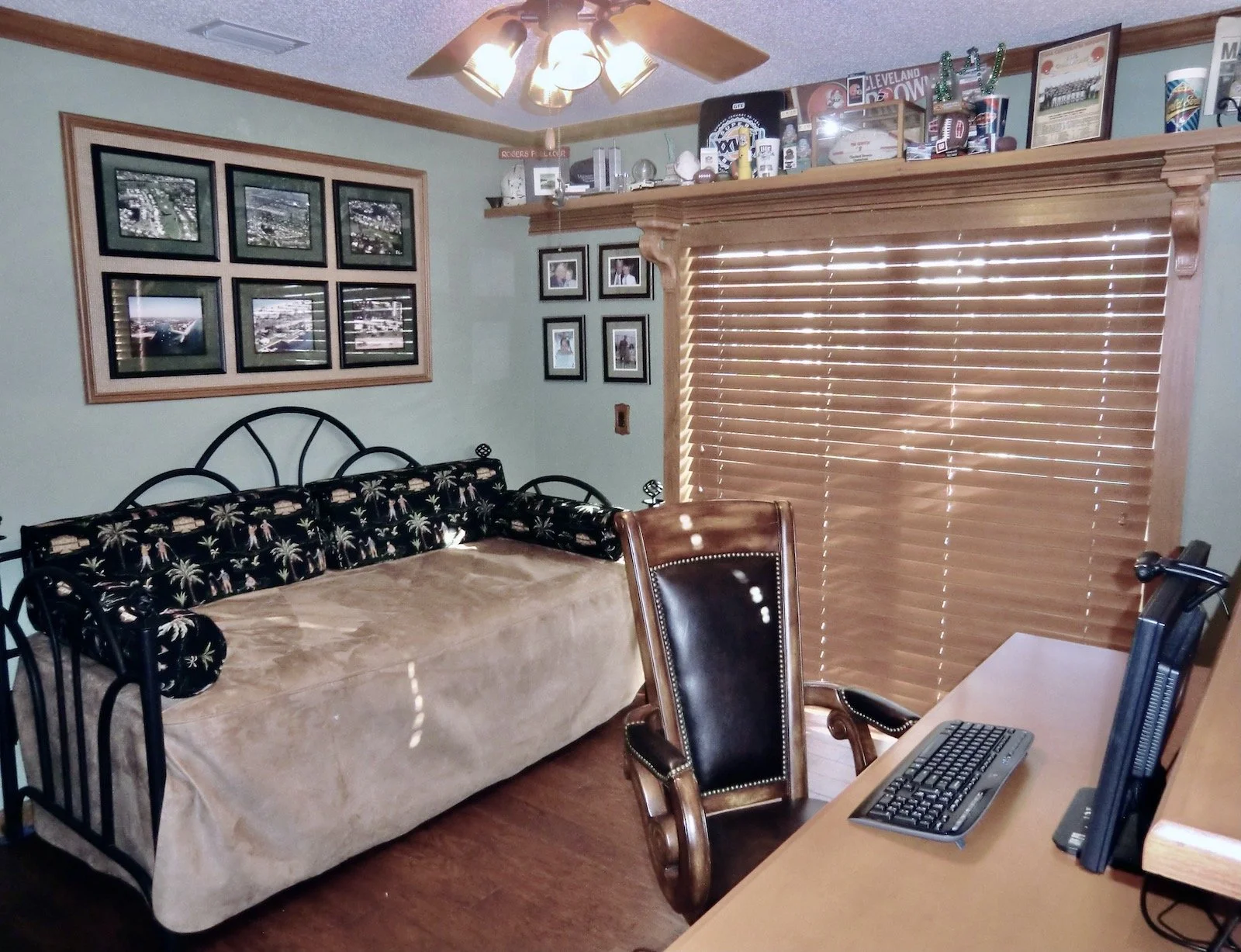 transitional home office with daybed and wooden blinds to match custom cabinetry with shelf and traditional corbels