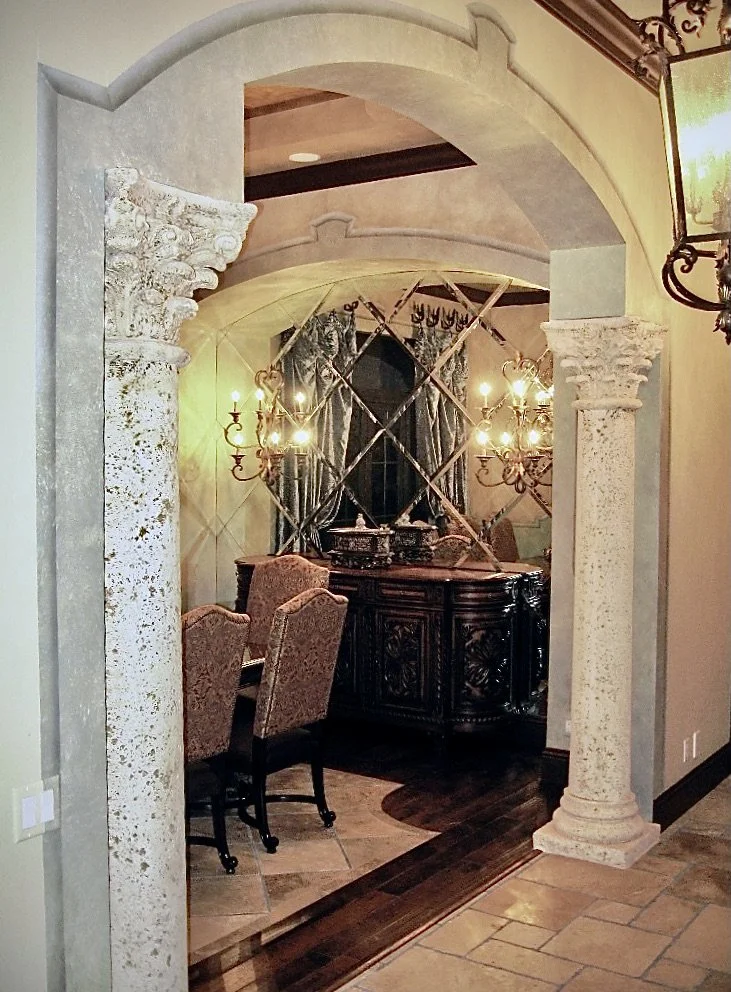 Traditional Mediterranean style dining room with arched niche and columns in Weston