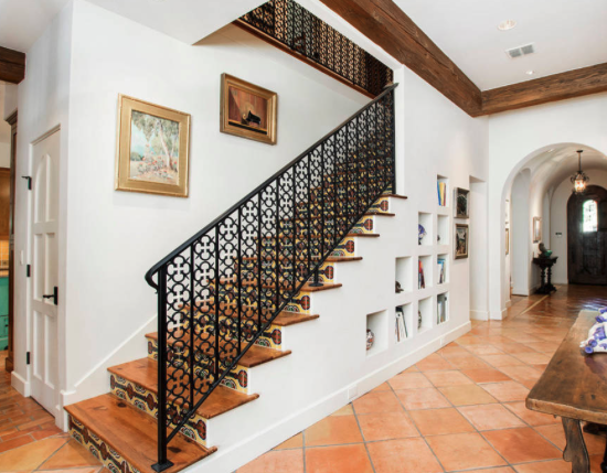 Mediterranean staircase tile and wrought-iron
