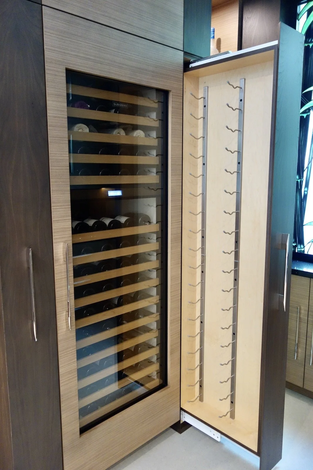 custom cabinetry home bar with sub-zero wine refrigerator and pull out wine racks in Fort Lauderdale