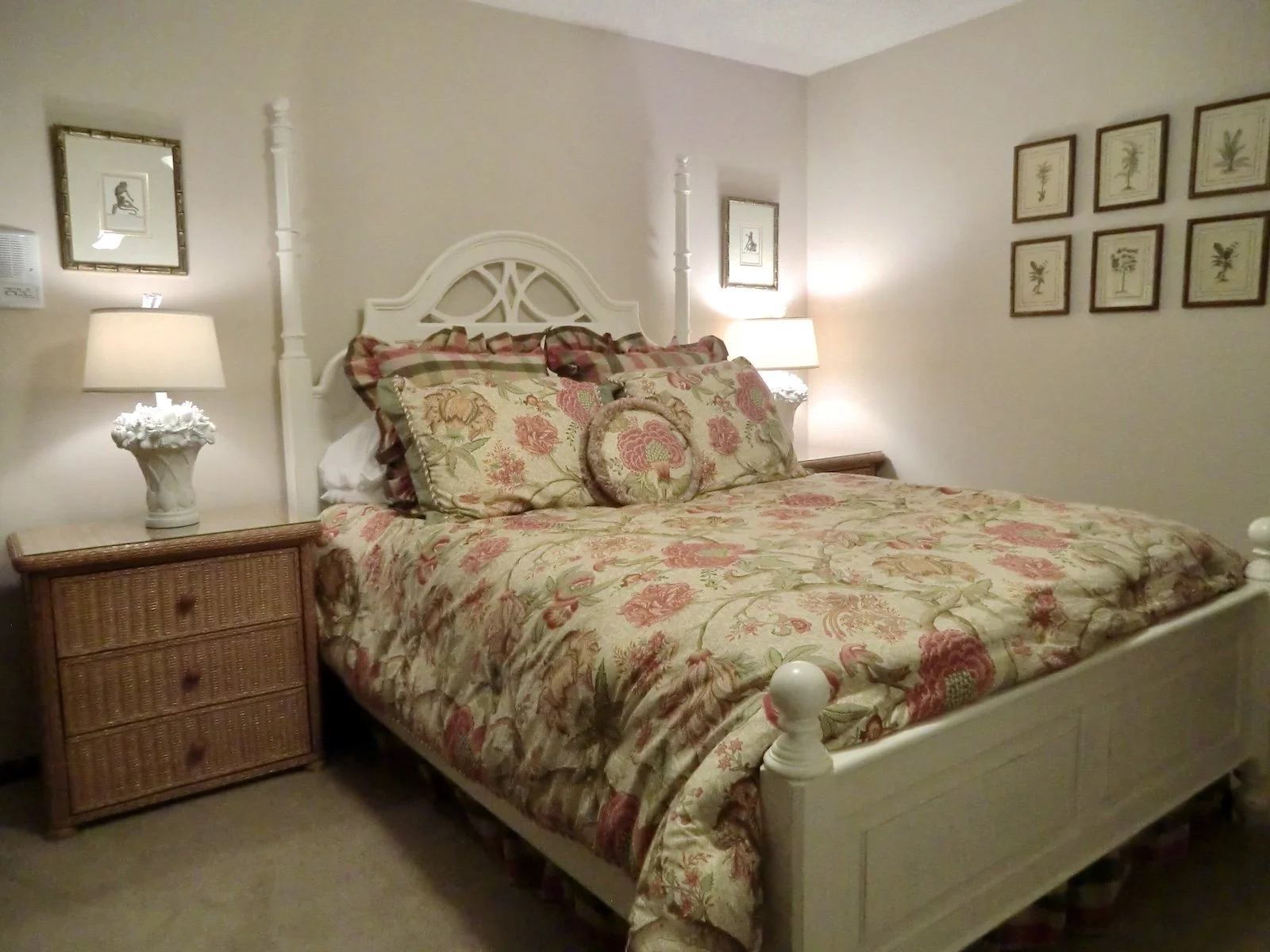 coastal style bedroom with tropical bedspread, white furniture and Ratan nightstands in Palm Beach