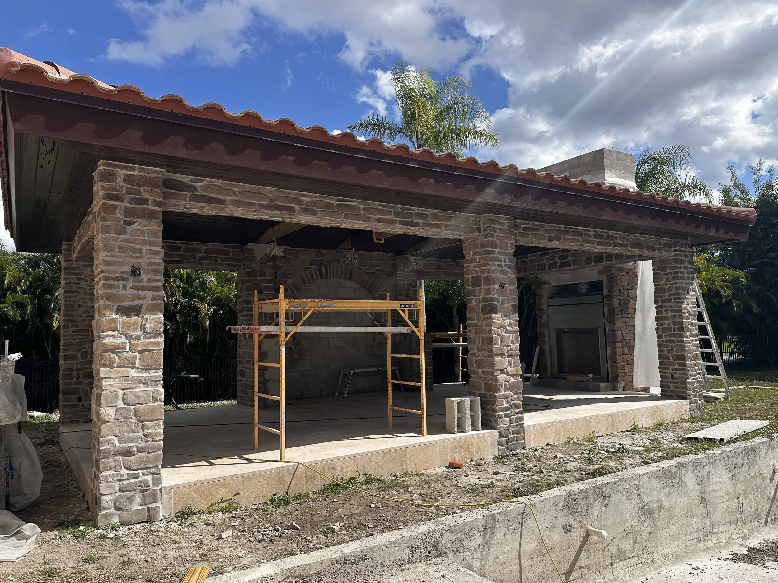 Mediterranean design-build stone gazebo in Boca Raton under construction with columns and tile roof