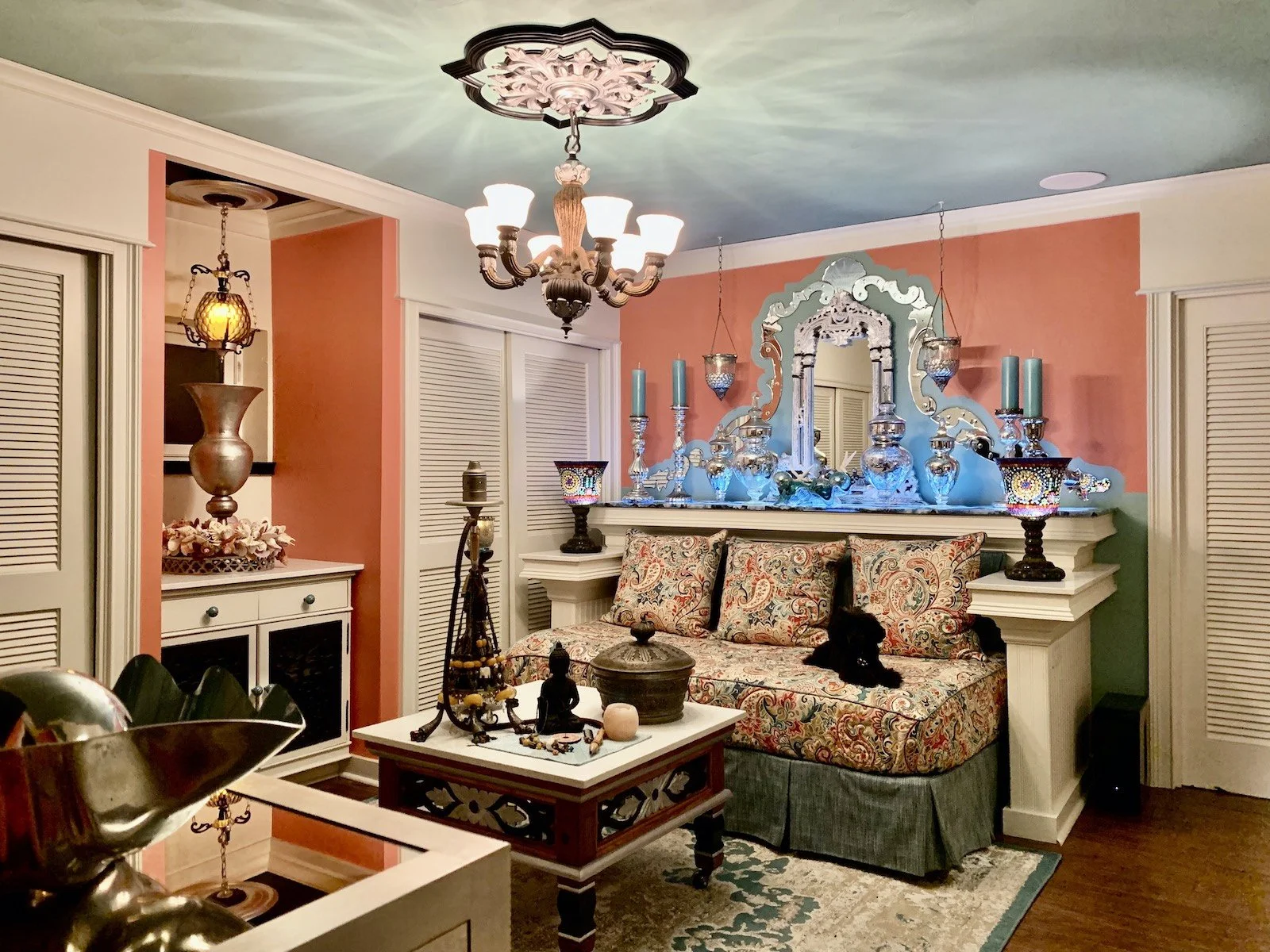 Colorful Mediterranean media room with day bed, Venetian mirror and blue agate
