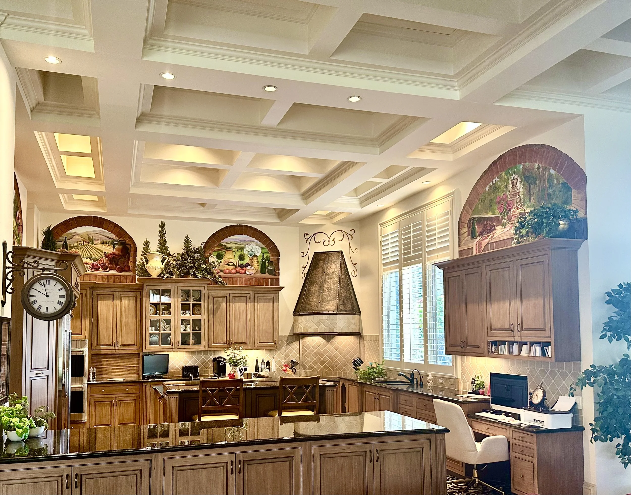 Traditional kitchen with custom cabinetry and metal range hood