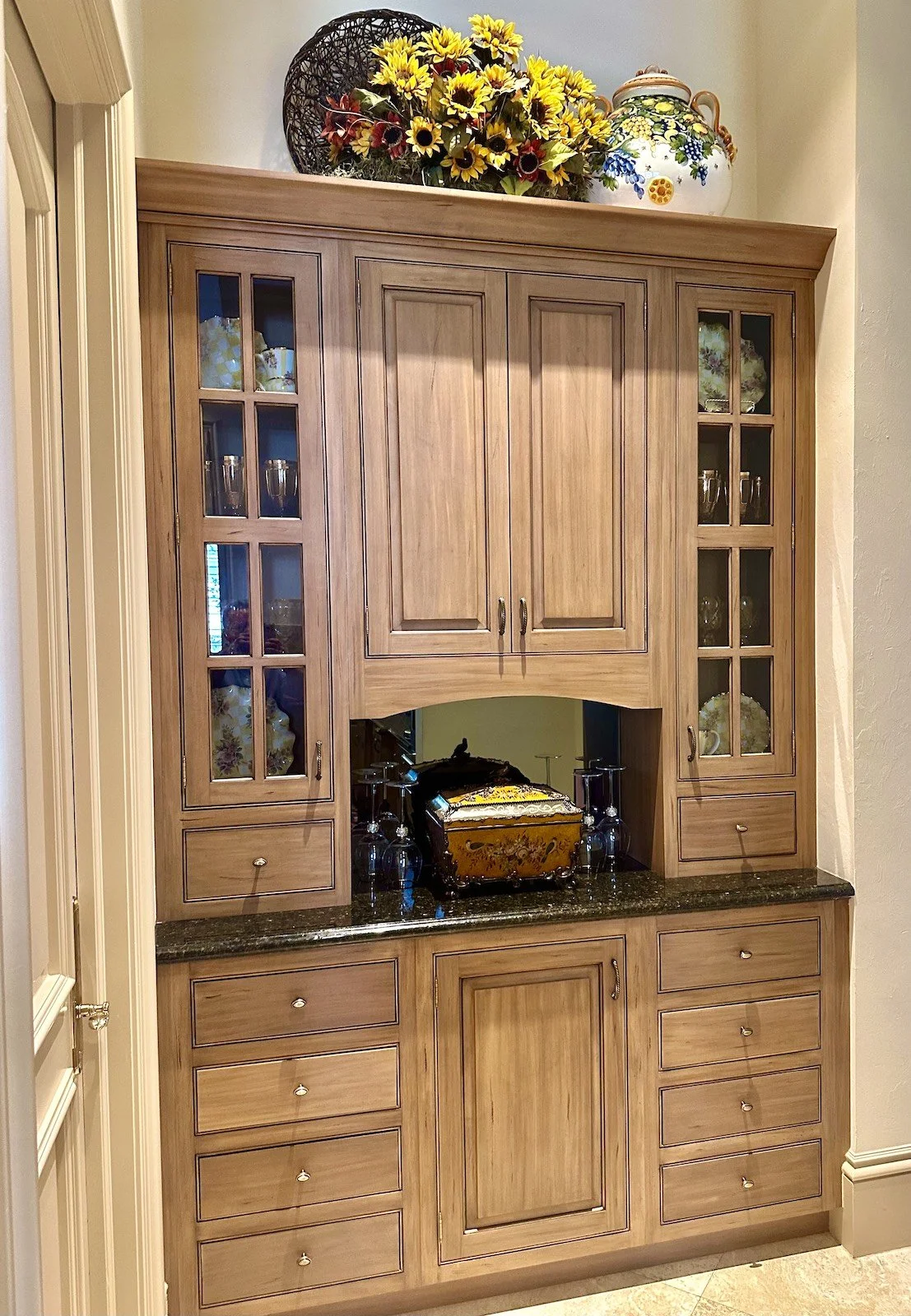 traditional custom kitchen cabinets with glass doors and arched niche