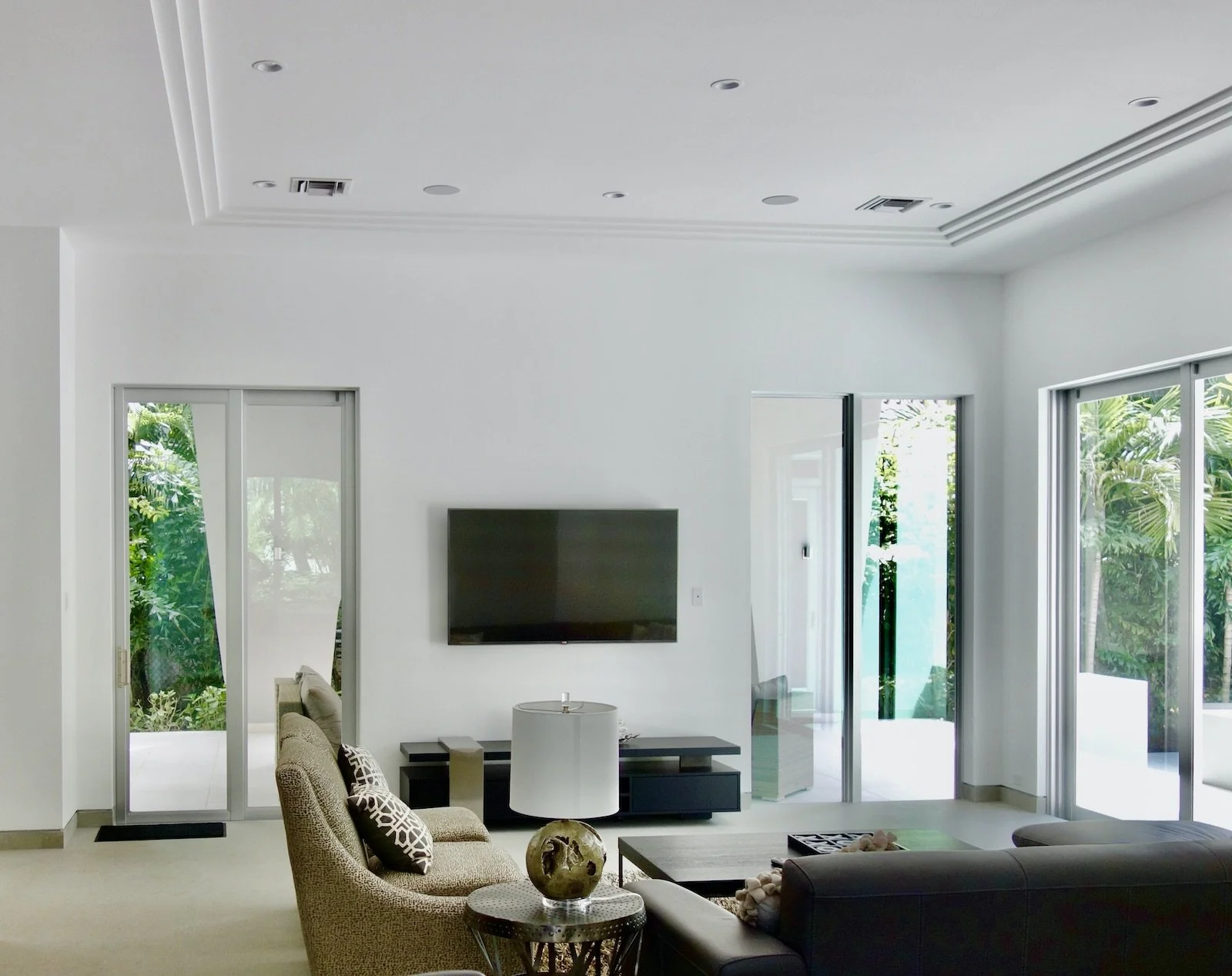Before family room remodel with architectural tv wall has stone and dark wood detail in Fort Lauderdale home