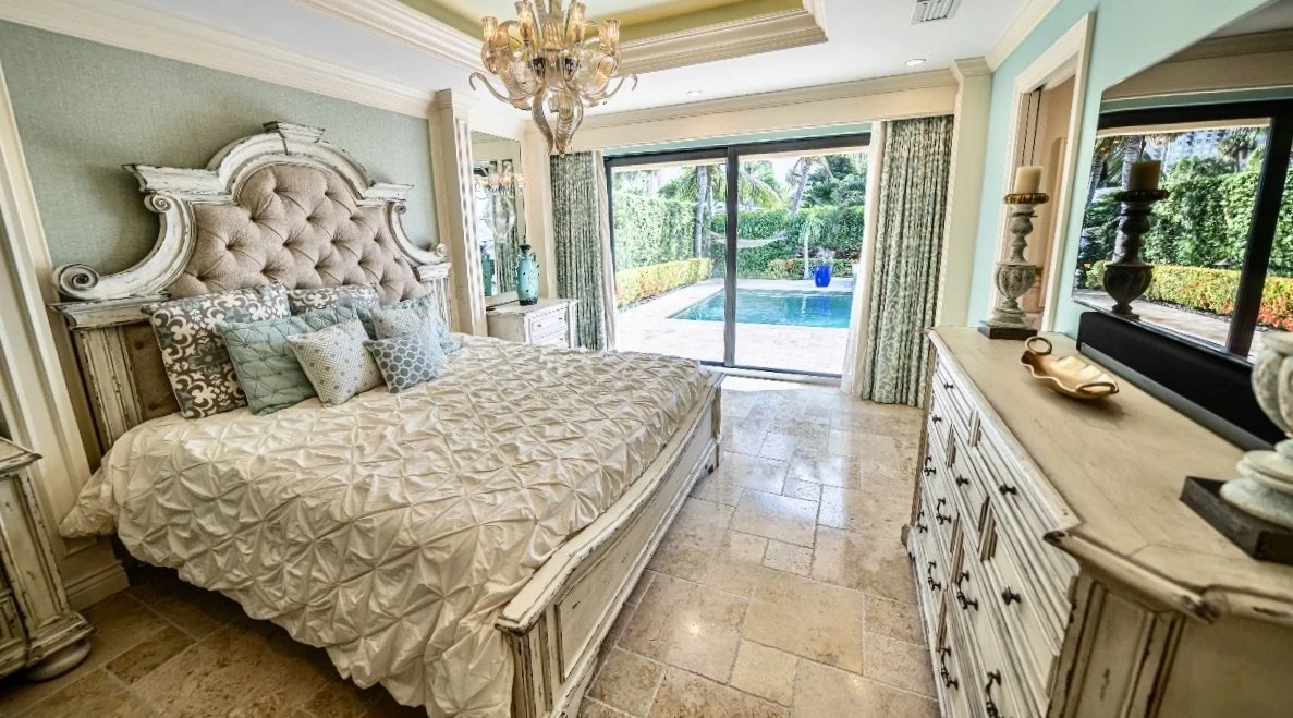 traditional interior design of this coastal bedroom with sconces in Fort Lauderdale