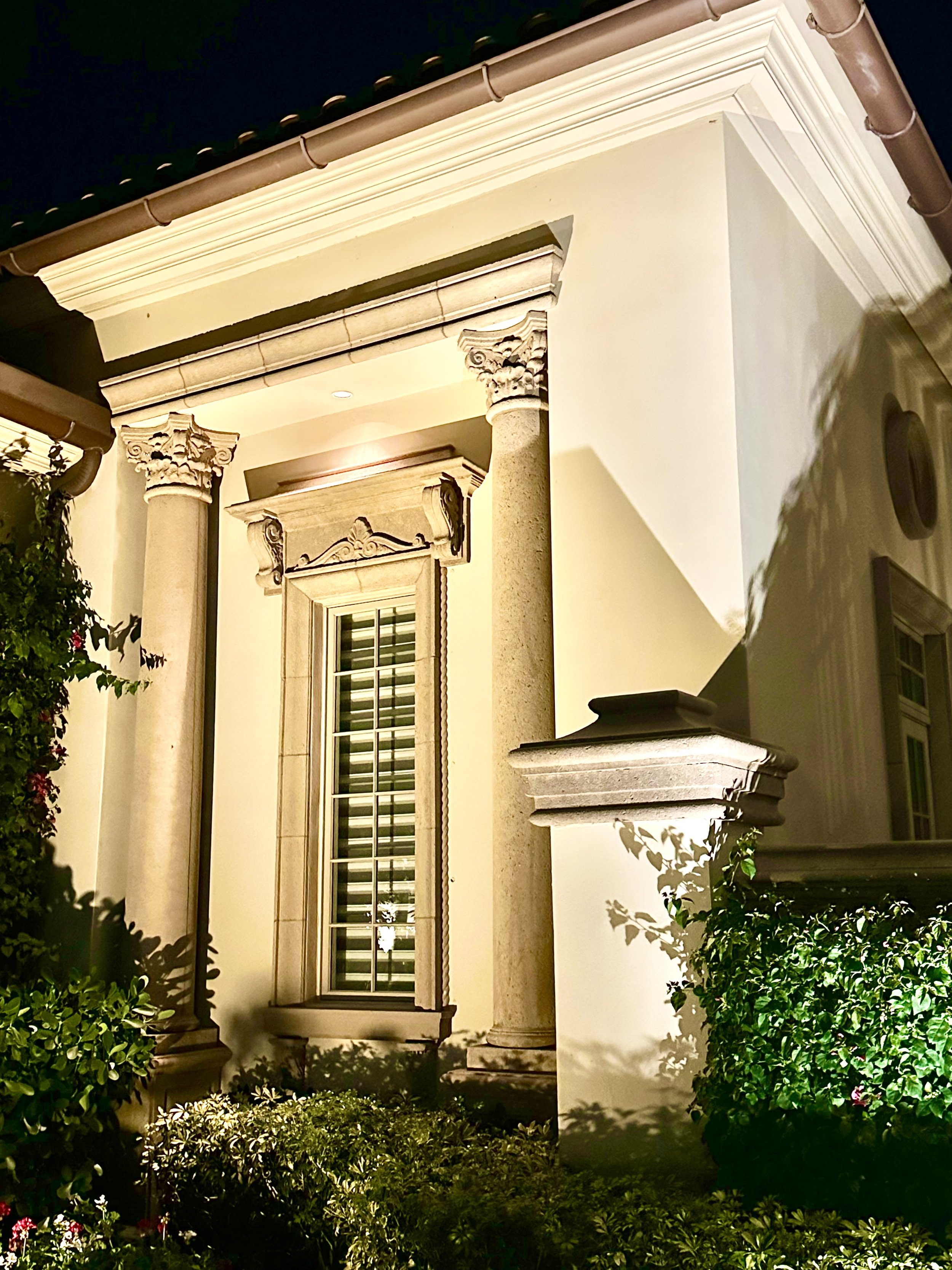 Mediterranean stone columns and molding around window in Jupiter