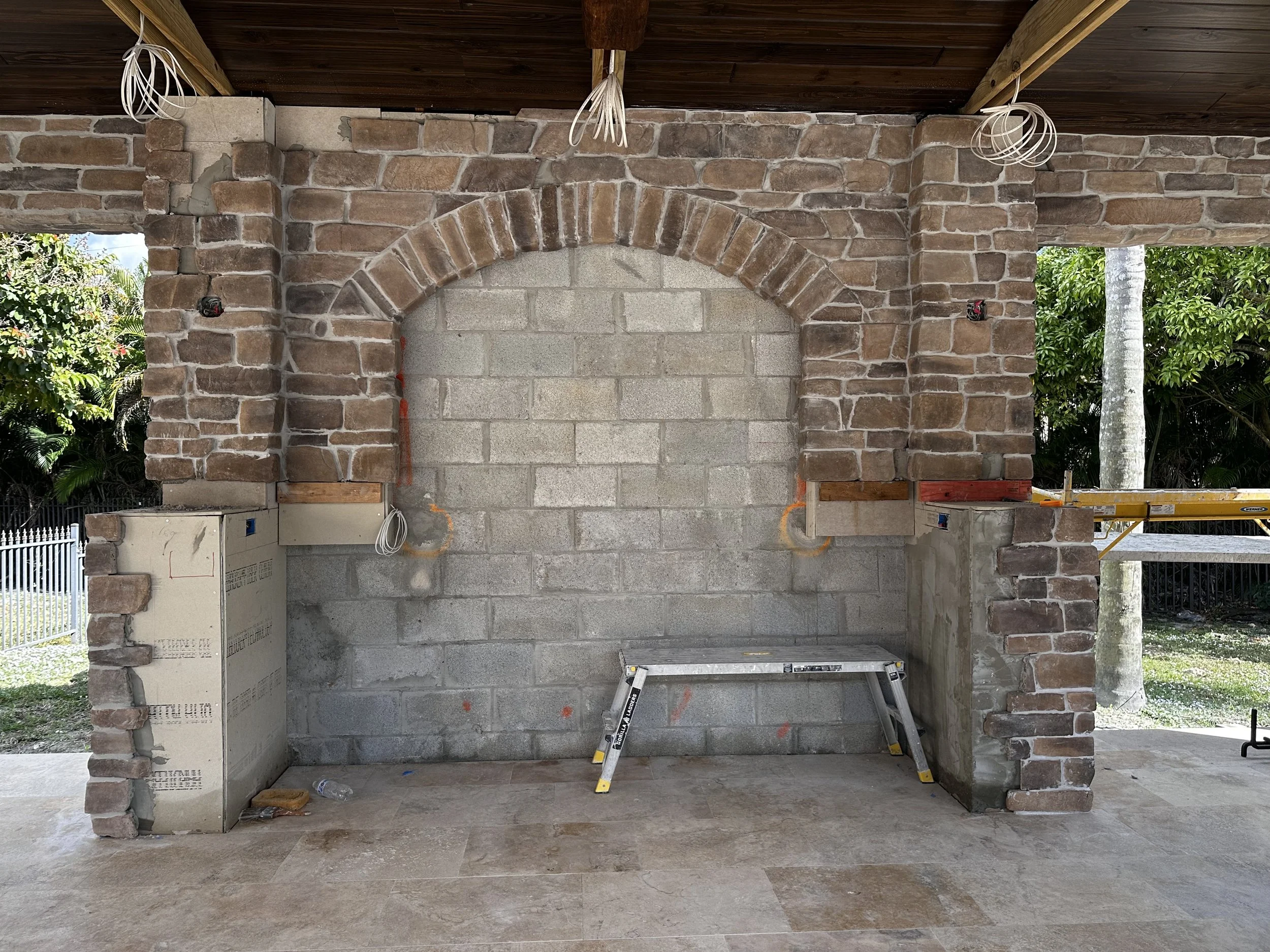 Boca Raton stone Gazebo with bar having stone columns, arch, and tile mural