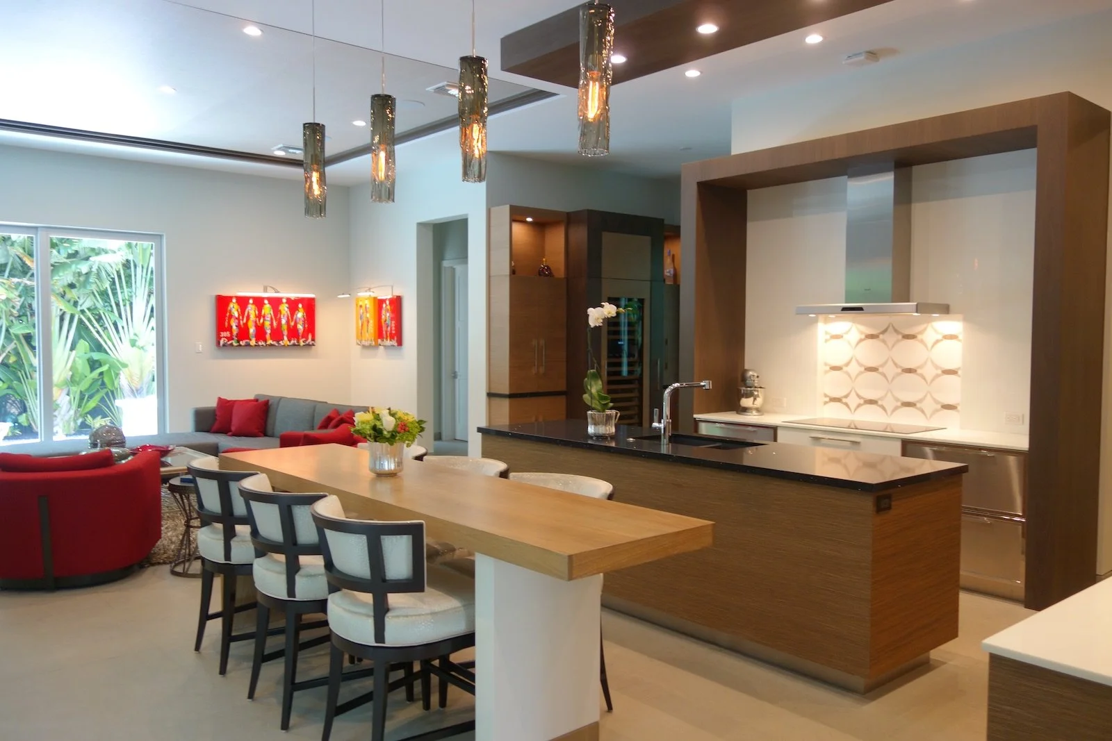 modern kitchen has island with seating of six and sink island, custom cabinets for cook top with architectural bridge