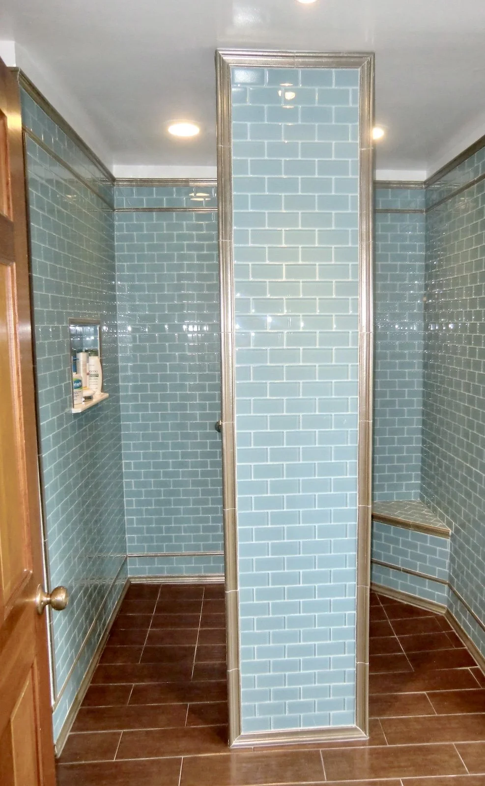 Coastal bathroom remodel with aqua glass tiles in Palm Beach