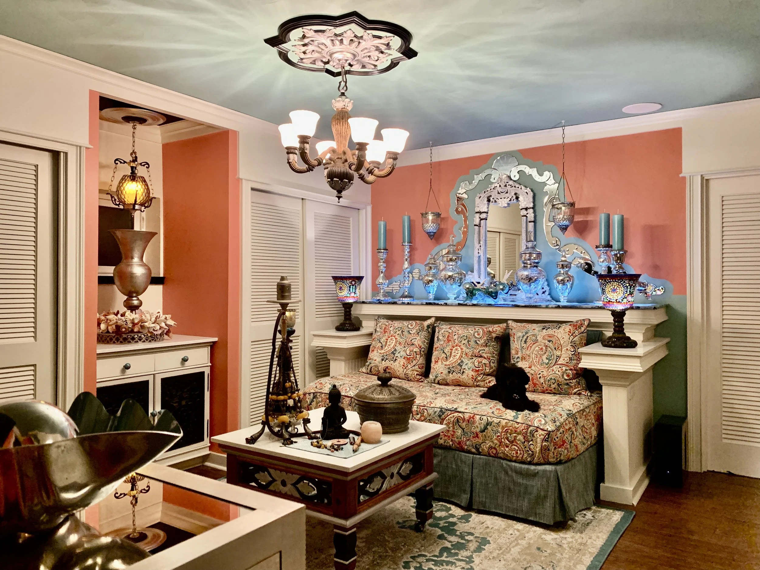 Colorful Mediterranean media room with day bed, Venetian mirror and blue agate