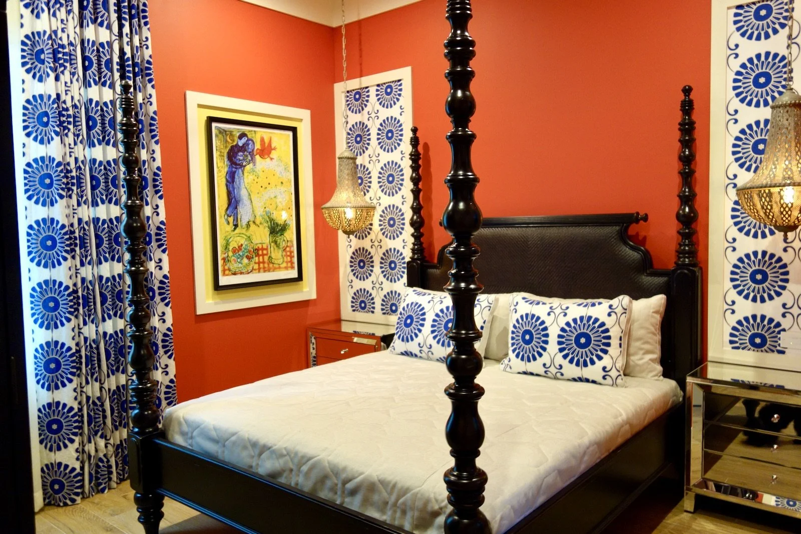 red bedroom with dark colonial four poster bed with Batik fabric and hanging silver lamps in Fort Lauderdale