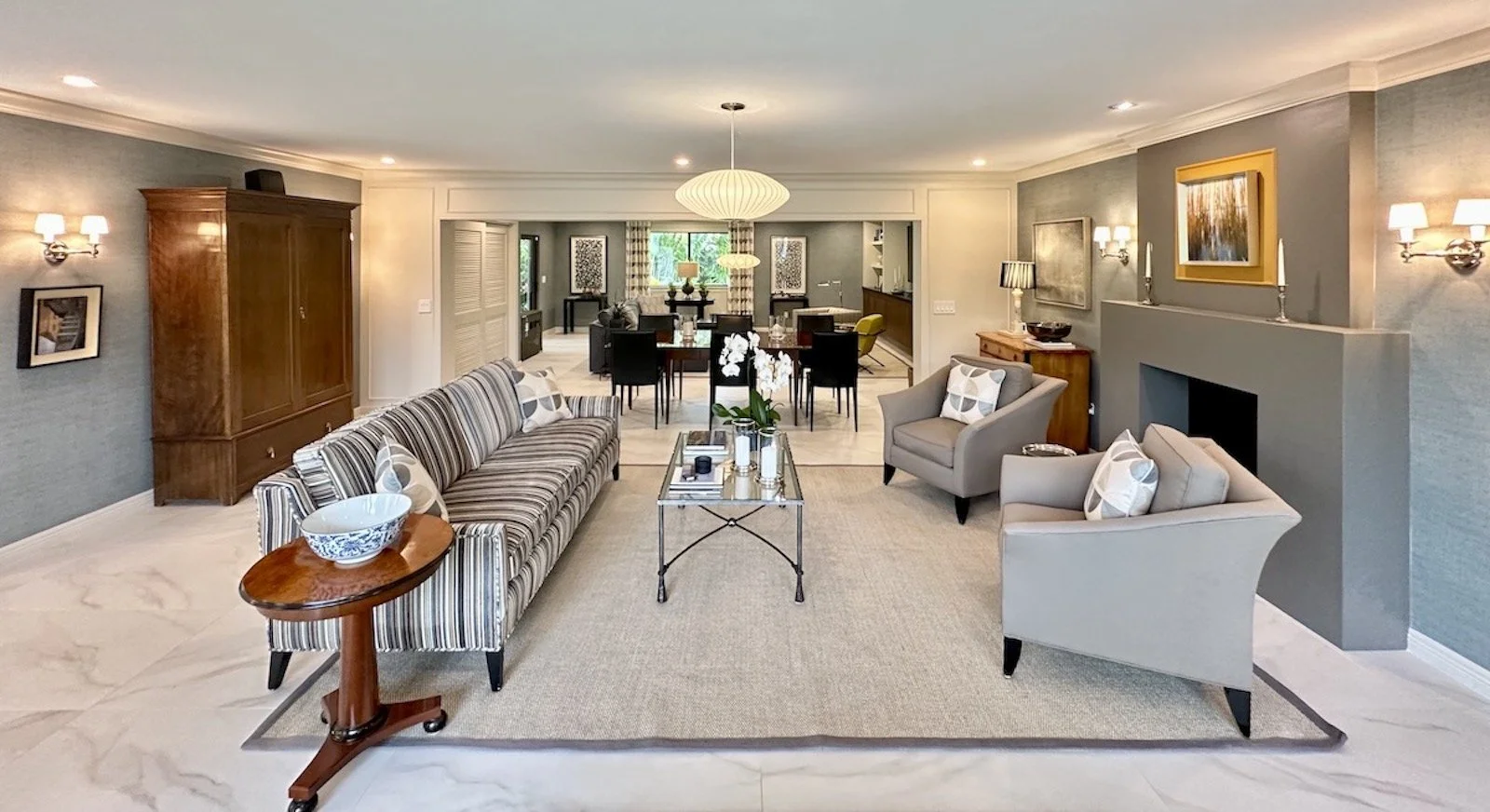 Transitional living room with sofa and two chairs in front of fireplace in Fort Lauderdale