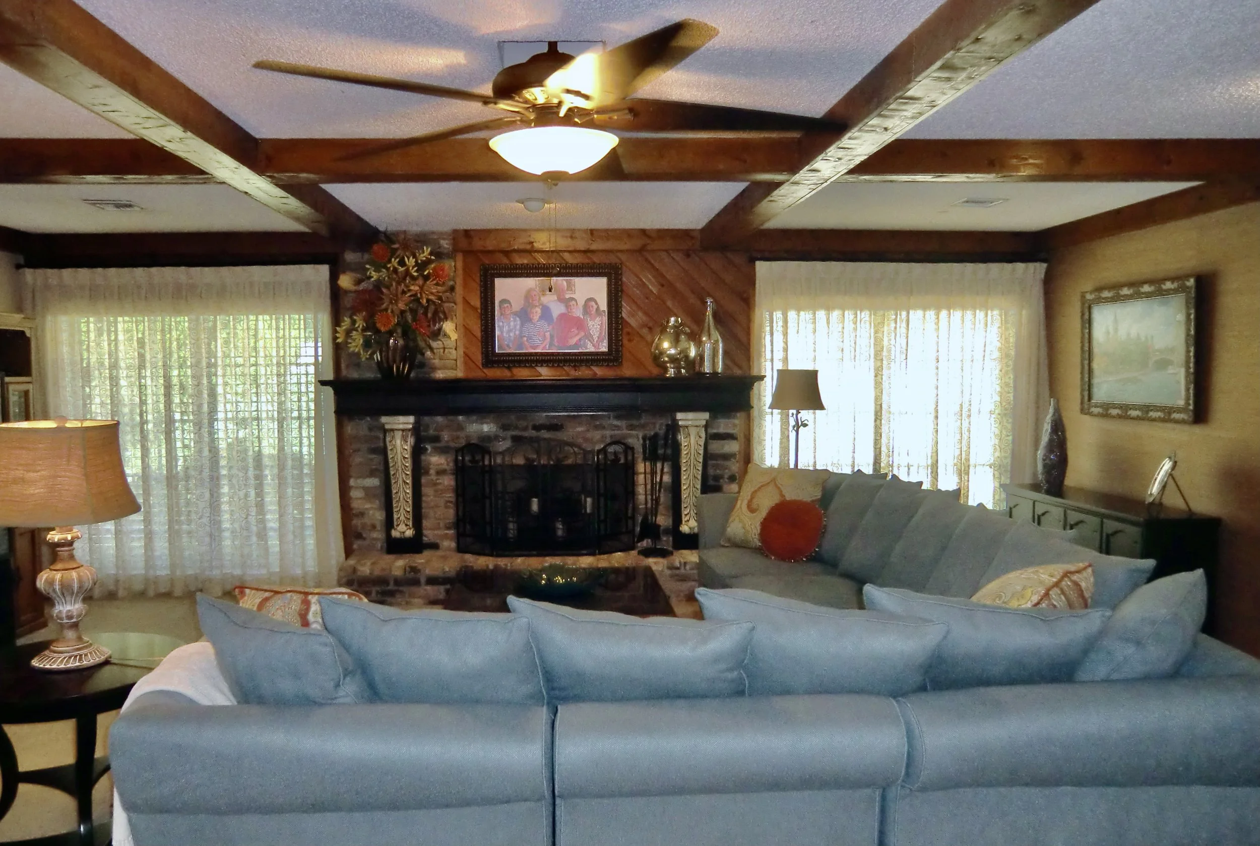 Coastal family room design with brick and wood fireplace in Delray Beach Florida